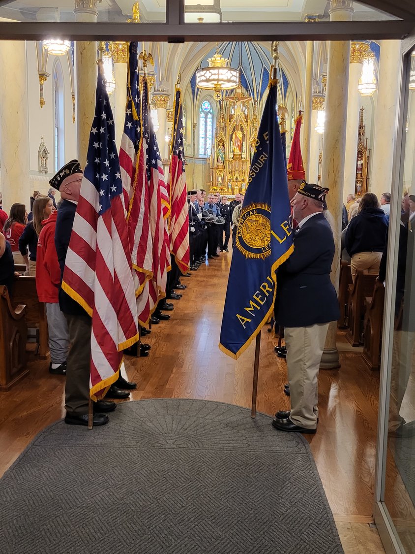 Members of various veterans organizations hold U.S. flags and banners during the Veterans Day Prayer Service on Nov. 11 in St. Peter Church in Jefferson City.